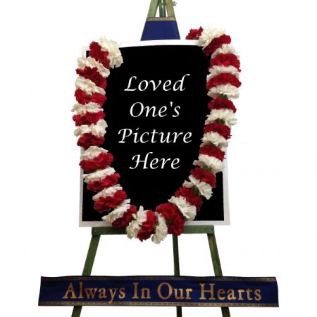 Conroy's Florist & Flower Delivery Mission Viejo - A lei tribute on an easel.  Banner color and text can be changed.  Colors of carnations can be changed.  Customer must provide picture. Picture, including the frame needs to be no larger than 30" x 24". 