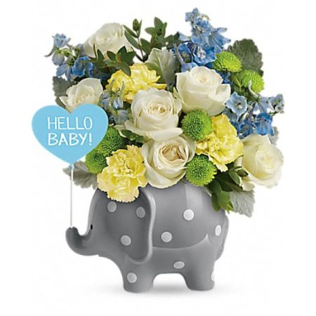 Conroy's Florist & Flower Delivery Mission Viejo - A delightful floral tribute to celebrate a new arrival. This charming arrangement, featuring an adorable ceramic elephant keepsake, is adorned with white roses, yellow carnations, blue delphiniums, and green athos pompoms. It's a visual feast of colors designed to delight the newborn and parents alike. 