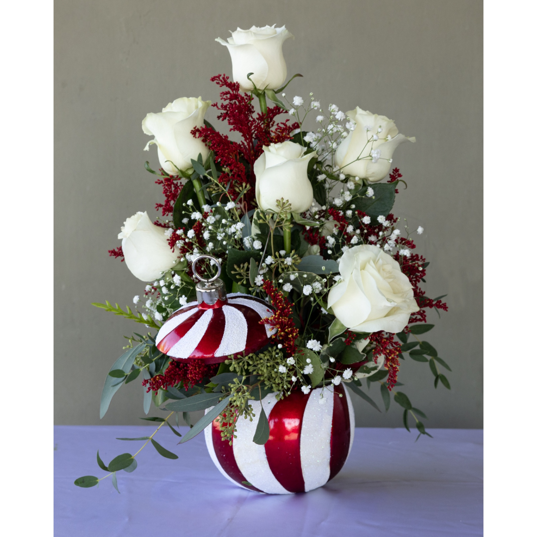 Conroy's Flowers Inglewood Inglewood - Embrace the festive holiday spirit with 'Frosted Ornament Lullaby - White.' This enchanting arrangement, nestled in a festive ornament ceramic container, showcases delightful shades of white that capture the magic of the season. Please note that containers may vary, adding a unique touch to your seasonal decor and making each arrangement special. With our same-day flower delivery, you can ensure that this charming creation graces your space promptly, bringing joy and festive cheer to your holiday celebrations. Capture the essence of the holidays with 'Frosted Ornament Lullaby - White' for a delightful and merry touch to your decor.