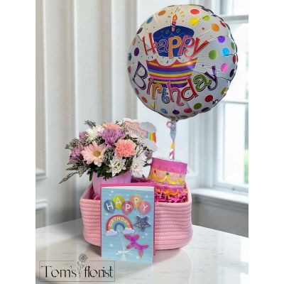 Tom's Florist Smyrna - Celebrate in style with our Happy Birthday Bundle—a joyful mix of sweet treats, colorful surprises, and fresh flowers. Perfect for making someone’s special day even more memorable, this bundle combines playful details with a thoughtful floral touch.

What’s included:

Small Pink Cake Piñata
A miniature birthday cake-shaped piñata, filled with assorted candy for a fun and sweet surprise.

Rainbow Happy Birthday Card
A cheerful, colorful card to share your personal message and birthday wishes.

Happy Birthday Confetti Cloud Pick
A festive accent that adds a pop of celebration to the flower arrangement or any birthday display.

Small Flower Arrangement in Pink Container
Designed to delight, our birthday blooms come in three stunning sizes:

Standard – A sweet blend of daisies and carnations for a fresh and classic look.

Deluxe – An elevated version replacing carnations with pink roses for added elegance.

Premium – The ultimate display of beauty with pink roses, carnations, and white daisies, creating a lush and luxurious bouquet.