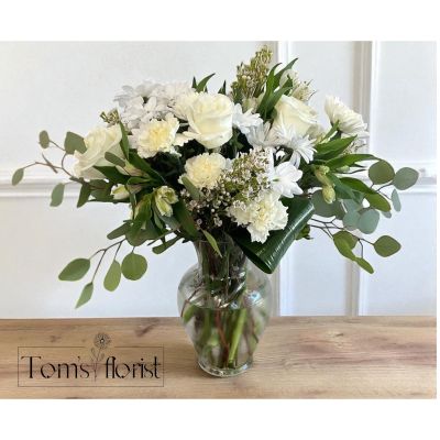 Tom's Florist Smyrna - An expression of pure elegance, White Flourish is a grand all-white floral arrangement that radiates grace and sophistication. Featuring a lush blend of premium white blooms, this luxurious design brings a sense of serenity and refined beauty to any space.

Whether you're offering comfort, celebrating a special moment, or simply elevating someone’s day, White Flourish delivers a timeless gesture of care and elegance. Its generous scale and classic palette make it perfect for both everyday occasions and heartfelt sympathy tributes.

Ideal for: Everyday, Sympathy, Thinking of You, Elegant Home Décor