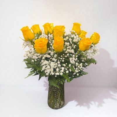 Tom's Florist Smyrna - Bright, cheerful, and full of warmth, this arrangement features one dozen premium yellow roses, beautifully accented with baby’s breath and lush greenery, all arranged in a classic clear glass vase.

Yellow roses are the perfect way to celebrate friendship, joy, and new beginnings — ideal for birthdays, congratulations, or simply to brighten someone’s day.

Includes vase and baby’s breath.

Please Note: To ensure availability of yellow roses, we kindly ask for at least one day’s notice when placing your order. Flower varieties and greenery may vary slightly based on seasonal availability.