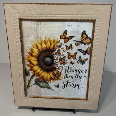 Tom's Florist Smyrna - Radiate resilience and beauty with our “Stronger Than the Storm” design. 

This powerful image features a vibrant sunflower gracefully transforming into fluttering butterflies — a stunning symbol of growth, hope, and renewal. 
Just like the sunflower that stands tall through every storm. 

This design reminds you that even in the toughest moments, you have the strength to rise and bloom again.

Size: 11'' x 13''