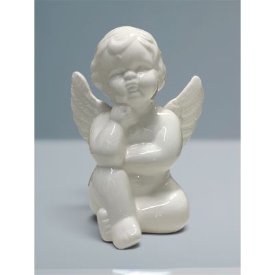 Tom's Florist Smyrna - A charming angel figurine featuring a sweet, peaceful expression and delicate wings. Crafted in a smooth, glossy white finish. It has a classic timeless look, its seated design adds a soft, sentimental touch to any floral arrangement, gift or home display.

A lovely keepsake that can be enjoyed for years to come. 

Figurine measures 6.5” inches
