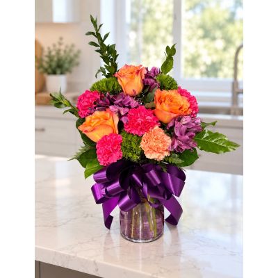 Tom's Florist Smyrna - Colorful arrangement in a purple vase.