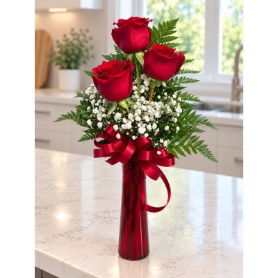 Tom's Florist Smyrna - Three red roses surrounded in dainty baby’s breath.