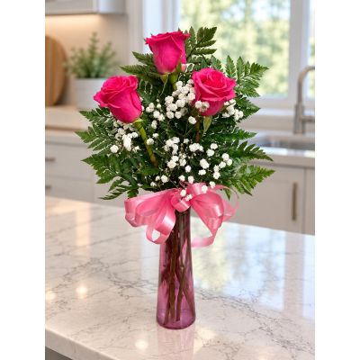 Tom's Florist Smyrna - Three hot pink roses surrounded in dainty baby’s breath