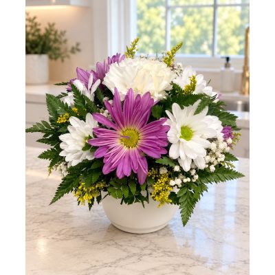 Tom's Florist Smyrna - This is a mini bouquet of soft purple daisies and white accents
