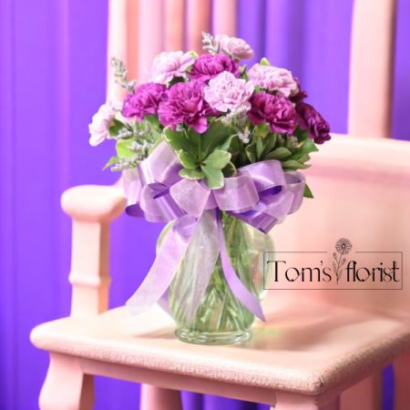 Tom's Florist Smyrna - Immerse yourself in a symphony of elegance and grace with our Heartfelt Harmony arrangement. Featuring a soothing blend of lavender and purple carnations, this stunning bouquet symbolizes admiration, love, and deep affection. The soft hues of lavender paired with the rich purple tones create a serene and balanced composition, making it the perfect expression of heartfelt emotions. Ideal for anniversaries, romantic gestures, or any occasion that calls for a meaningful touch, Heartfelt Harmony is sure to convey your sentiments with timeless beauty.