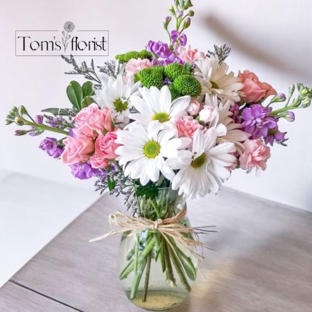 Tom's Florist Smyrna - Soft, vibrant, and full of charm, Darling Blooms is a delightful arrangement featuring a beautiful mix of white, pink, purple, and green flowers. Its playful yet elegant design makes it a perfect choice for birthdays, welcoming a new baby, or simply to brighten someone’s day. With a blend of soft pastels and fresh greenery, this arrangement conveys warmth, joy, and affection, making it a thoughtful gesture for any occasion. Let Darling Blooms bring a little extra sunshine and love to those you cherish.