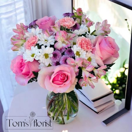 Tom's Florist Smyrna - A dreamy blend of elegance and charm, Pink Perfection lives up to its name in every petal. This lush, full arrangement bursts with the soft beauty of pink roses, alstroemeria, carnations, and button poms, delicately balanced with cheerful white daisies. Designed to impress, this large bouquet is perfect for celebrating life’s sweetest moments—birthdays, anniversaries, or just because.

Thoughtfully arranged to brighten any room, Pink Perfection is a radiant expression of love, joy, and heartfelt sentiment.