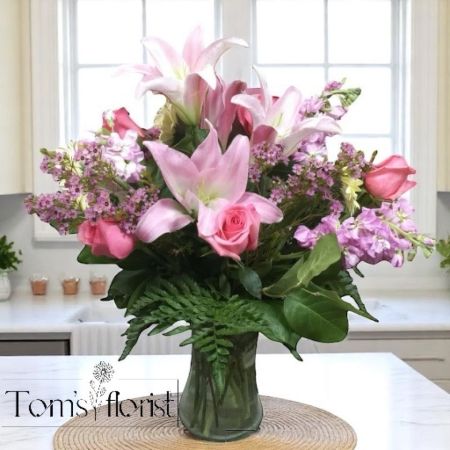 Tom's Florist Smyrna - Blush Luxe is the epitome of elegance—a breathtaking all-pink arrangement designed to captivate with its refined beauty and luxurious presence. Featuring lush pink roses and graceful pink lilies, this arrangement is artfully styled to highlight the soft, romantic charm of each bloom.

Presented in a premium vessel and arranged with precision, Blush Luxe makes a stunning statement for life’s most cherished moments—from anniversaries and celebrations to simply saying “you’re extraordinary.”

Soft yet striking, classic yet modern—Blush Luxe is a timeless floral indulgence that leaves a lasting impression.