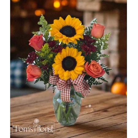 Tom's Florist Smyrna - Celebrate the warmth and color of the season with Sunflower Spice — a cheerful burst of fall in floral form. Featuring bold, golden sunflowers surrounded by rich autumn-toned blooms like vibrant oranges, deep reds, and rustic accents, this arrangement brings cozy harvest vibes to any space.

Perfect for seasonal décor, thoughtful gifting, or simply adding a little fall joy to your day.

Please note: Flower varieties and colors may vary slightly due to seasonal availability — but the warm, autumn-inspired palette will always shine through.