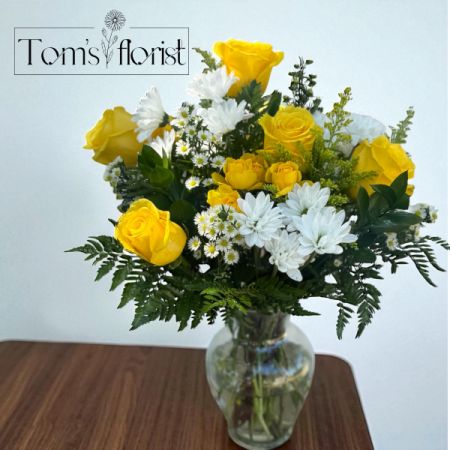 Tom's Florist Smyrna - Bring a sense of warmth and light to any space with our Golden Glow Bouquet. This radiant arrangement features a soft blend of golden yellow and creamy white blooms, artfully designed to evoke peace, comfort, and natural beauty. Whether you're marking a thoughtful occasion, offering your sympathy, or simply brightening someone's day, the Golden Glow Bouquet is a timeless gesture of care and grace.

Perfect for: Everyday gifting, sympathy, get well, or just because.