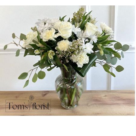 Tom's Florist Smyrna - An expression of pure elegance, White Flourish is a grand all-white floral arrangement that radiates grace and sophistication. Featuring a lush blend of premium white blooms, this luxurious design brings a sense of serenity and refined beauty to any space.

Whether you're offering comfort, celebrating a special moment, or simply elevating someone’s day, White Flourish delivers a timeless gesture of care and elegance. Its generous scale and classic palette make it perfect for both everyday occasions and heartfelt sympathy tributes.

Ideal for: Everyday, Sympathy, Thinking of You, Elegant Home Décor