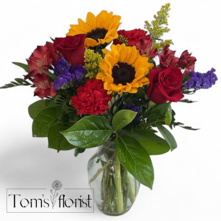 Tom's Florist Smyrna - This Arrangement brings together the rich passion of red, the cheerful warmth of yellow, and the royal charm of purple in a beautifully balanced bouquet. 

Perfect for birthdays, celebrations, or brightening someone’s day.
