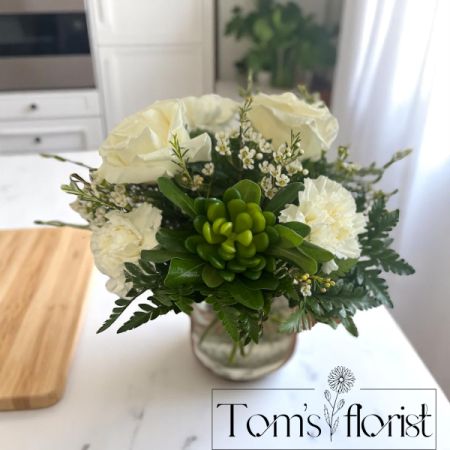 Tom's Florist Smyrna - A charming blend of beauty and texture, our Sweetest Succulent arrangement brings a touch of whimsy to any space. 
Featuring fresh roses, delicate carnations, and airy wax flowers, this petite design is accented with a lifelike faux succulent pick for a trendy twist. 
Succulent styles may vary based on availability, adding a unique touch to each arrangement. 
Perfect for desks, side tables, or as a thoughtful gift, this small but sweet bouquet delivers big smiles.