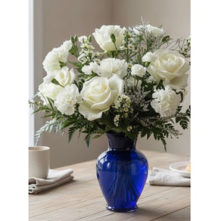 Tom's Florist Smyrna - Make a bold and beautiful statement with this striking blue flower arrangement. Featuring a harmonious mix of roses, carnations, mini carnations, and monte, each bloom is carefully selected to create depth, texture, and visual interest.

Presented in a cobalt blue vase, this arrangement brings a modern, elegant touch to any space, making it perfect for home décor, office accents, or special occasions. Its cool tones and lush blooms convey calm, sophistication, and thoughtful care.

Ideal for, anniversaries, Sympathy, or simply to brighten someone’s day