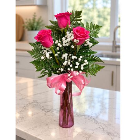 Tom's Florist Smyrna - Three hot pink roses surrounded in dainty baby’s breath