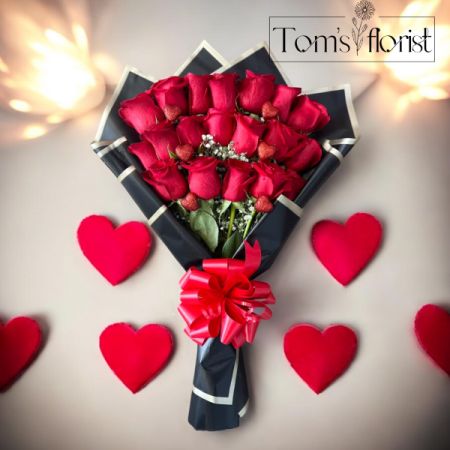 Tom's Florist Smyrna - Celebrate love, passion, and elegance with our Premium Hand-Wrapped Dozen Red Roses. Each exquisite rose is carefully selected for its vibrant, velvety petals and deep, rich color, symbolizing timeless romance. Expertly arranged by our skilled florists, these roses are lovingly hand-wrapped in luxurious paper, creating a sophisticated and refined presentation.

Perfect for anniversaries, romantic gestures, or any occasion where you want to leave a lasting impression, this bouquet is a true expression of love and admiration. Whether for a special someone or to make a grand gesture, these roses are sure to convey your deepest emotions with elegance and grace.

Features:

- 12 premium long-stemmed red roses
- Hand-wrapped with care in high-quality paper
- Fresh, hand-selected blooms for optimal beauty and longevity
- A perfect gift for romantic occasions, anniversaries, or celebrations

Show someone just how much they mean to you with this stunning bouquet. Fresh, elegant, and undeniably romantic, our Premium Hand-Wrapped Dozen Red Roses will make any moment unforgettable.

