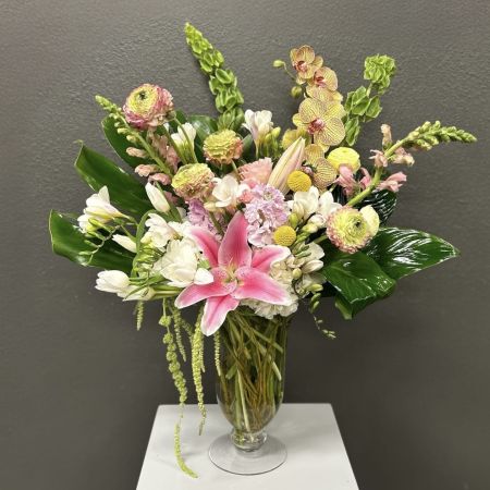 Conroy's Flowers San Diego San Diego - A stunning mix of pink lilies, orchids, soft pastels, and glossy greens arranged tall and full—bringing a fresh, tropical elegance to any space or special occasion.

**Flowers and vase my vary based on availability. We will preserve the color palette and theme of the design.
