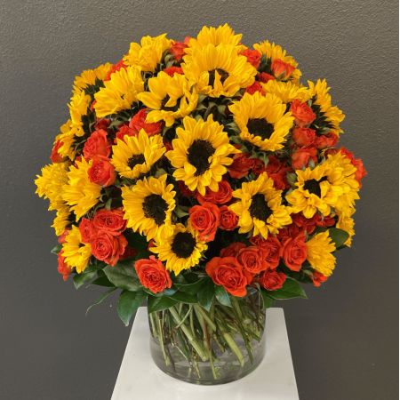 Conroy's Flowers San Diego San Diego - A bold and cheerful arrangement of radiant sunflowers and fiery orange roses, overflowing with warmth, happiness, and feel-good energy—perfect for making any space instantly brighter.

**Flowers and vase my vary based on availability. We will preserve the color palette and theme of the design.
