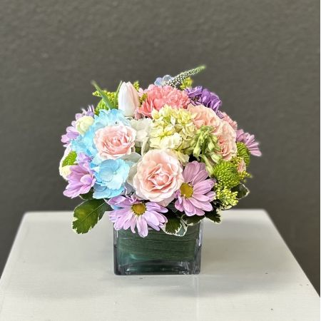 Conroy's Flowers San Diego San Diego - A charming mix of soft pinks, dreamy blues, and gentle purples arranged in a modern glass cube—perfect for adding a fresh, happy touch to any room or celebration.

**Flowers and vase my vary based on availability. We will preserve the color palette and theme of the design.
