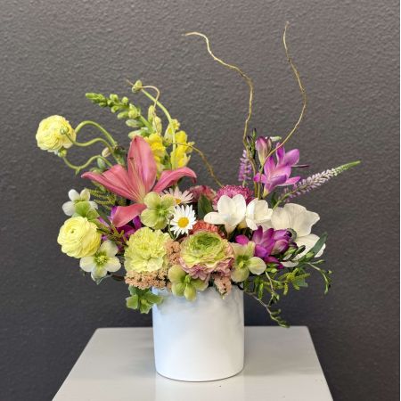 Conroy's Flowers San Diego San Diego - An artful celebration of nature, this garden-style arrangement blends vibrant lilies, ranunculus, freesia, anemones, and soft seasonal blooms in a harmonious palette of pinks, yellows, greens, and creams. Accented with whimsical branches and fresh greenery, it creates movement, texture, and joyful elegance. Perfect for spring celebrations, creative spaces, or anyone who loves flowers with a fresh, modern garden feel.

**Flowers and vase my vary based on availability. We will preserve the color palette and theme of the design.

