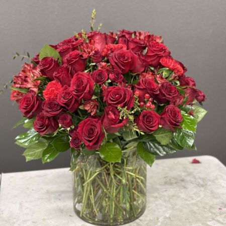 Conroy's Flowers San Diego San Diego - Bold, romantic, and irresistibly luxurious, this stunning arrangement overflows with rich red roses nestled among glossy green foliage. Designed to make a powerful statement, it embodies passion, devotion, and timeless elegance. Perfect for anniversaries, grand romantic gestures, or whenever words aren’t enough to express deep love.

**Flowers and vase my vary based on availability. We will preserve the color palette and theme of the design.

