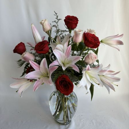 Conroy's Flowers San Diego San Diego - A graceful blend of velvety red roses and soft pink lilies, this arrangement captures timeless romance and refined beauty. Nestled with delicate greenery and displayed in a clear glass vase, each bloom unfolds with elegance and charm. Perfect for anniversaries, heartfelt celebrations, or simply to bring a touch of luxury and warmth into any space.

**Flowers and vase my vary based on availability. We will preserve the color palette and theme of the design.
