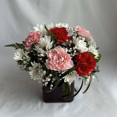 Conroy's Flowers San Diego San Diego - A refined blend of blush and crimson carnations with crisp white blooms, gracefully arranged in a sleek glass vase. Soft textures and balanced tones create an understated elegance—romantic, timeless, and effortlessly luxurious.