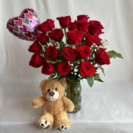Conroy's Flowers San Diego San Diego - An opulent arrangement of velvety red roses, elegantly displayed in a clear glass vase and accented with delicate baby’s breath. Paired with a charming plush teddy bear and a shimmering heart balloon, this gift exudes timeless romance, warmth, and refined luxury—perfect for making a heartfelt statement.