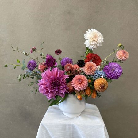 Conroy's Flowers San Diego San Diego - A lavish gathering of dahlias in rich jewel tones and soft pastels, thoughtfully arranged to feel both artful and abundant. Elegant yet expressive, this design brings couture-level beauty and quiet drama to any interior.