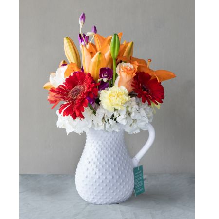 Conroy's Flowers El Cajon El Cajon - Presenting our exquisite Tutti-frutti Bouquet! Nestled in a charming white ceramic pitcher, this floral arrangement showcases a captivating fusion of orange and purple hues. Like a delectable medley of fruits, it exudes freshness and elegance, adding a vibrant and delightful touch to any space or celebration. With our same-day flower delivery, you can promptly bring the lively and colorful energy of the Tutti-frutti Bouquet to brighten up any occasion. It's a perfect choice for those who appreciate a unique and refreshing burst of floral beauty.





