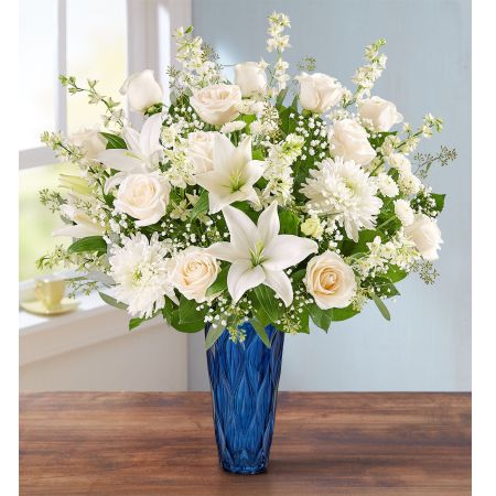 Conroy's Flowers El Cajon El Cajon - Honor the memory of someone dearly loved with "Peaceful Harmony™ Luxury." This abundant arrangement is filled with a soothing gathering of white blooms and lush greenery. It is designed in our graceful Blue Harmony vase, providing a touching way to honor their memory while conveying heartfelt condolences. With our same-day flower delivery, you can promptly share this comforting and luxurious arrangement with those who are mourning. "Peaceful Harmony™ Luxury" is a beautiful and elegant expression that brings solace and warmth during challenging moments, offering support and comfort.





