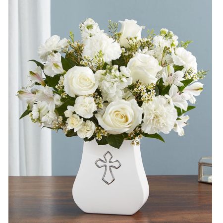 Conroy's Flowers El Cajon El Cajon - Bring peace to your loved ones during difficult times with "Sacred Blessings™ All White." This timeless arrangement of pure white flowers is elegantly gathered in our Sacred Blessings vase, featuring a silver-embossed cross an eternal symbol of hope. It is a truly comforting gesture to express your deepest condolences. With our same-day flower delivery, you can promptly share this comforting arrangement with those who are mourning. "Sacred Blessings™ All White" is a thoughtful and elegant expression that brings solace and warmth during challenging moments, offering support and comfort.





