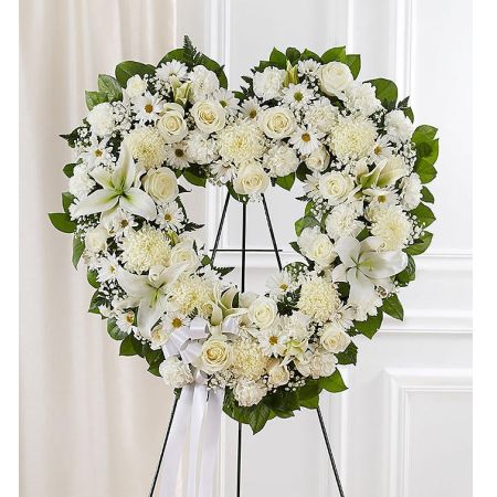Conroy's Flowers El Cajon El Cajon - The Always Remember Floral Heart Tribute in White is a poignant expression of enduring love and remembrance. Crafted with care by our compassionate florists, this standing, open heart-shaped arrangement features flawless white blooms. The all-white color palette symbolizes purity and offers a serene and elegant tribute to the departed. Meticulously designed, this arrangement serves as a magnificent and fitting tribute for funeral services, conveying heartfelt condolences and expressing the everlasting love that will keep the departed always remembered.