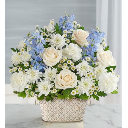 Conroy's Flowers El Cajon El Cajon - Celebrate the life of a loved one with "Loving Remembrance™ Blue and White." This beautiful floral tribute features a mix of blooms in soothing shades, symbolizing enduring love. Designed in our Remembrance Cachepot, featuring an embossed pattern and finished with a gold brushed ivory surface, this arrangement serves as a heartfelt expression. With our same-day flower delivery, you can promptly share this meaningful tribute with those who are mourning. "Loving Remembrance™ Blue and White" is a touching and elegant arrangement that brings solace and warmth during challenging moments, offering comfort and support.