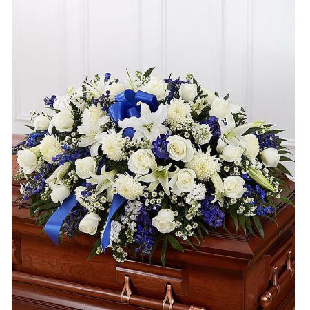 Conroy's Flowers El Cajon El Cajon - Honor a life so beautifully lived with a proud display of blue and white blooms. Our half casket cover, crafted with care and artistry by our expert florists with blue delphinium, white roses, and accented with a blue satin ribbon, is an unforgettable way to commemorate a lifetime of loving devotion.