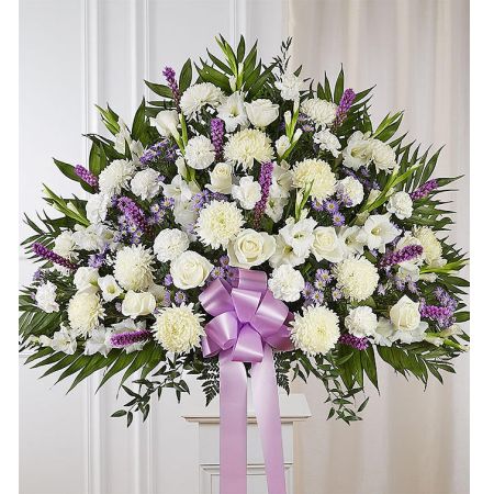 Conroy's Flowers El Cajon El Cajon - One who has touched the lives of many deserves to be honored in a uniquely touching way. Our majestic standing basket arrangement in lavender and white is an impressive tribute to their memory. Artistically designed by expert florists with an abundance of soft, lavender-hued and white blooms, it is a heartfelt expression of your deepest sympathies.<br/><br/>