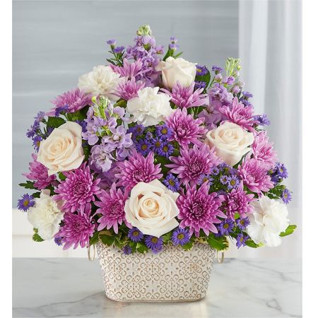 Conroy's Flowers El Cajon El Cajon - Celebrate the life of a loved one with "Loving Remembrance™ Lavender and White." This beautiful floral tribute features a mix of blooms in soothing shades, symbolizing enduring love. Designed in our Remembrance Cachepot, featuring an embossed pattern and finished with a gold brushed ivory surface, this arrangement serves as a heartfelt expression. With our same-day flower delivery, you can promptly share this meaningful tribute with those who are mourning. "Loving Remembrance™ Lavender and White" is a touching and elegant arrangement that brings solace and warmth during challenging moments, offering comfort and support.