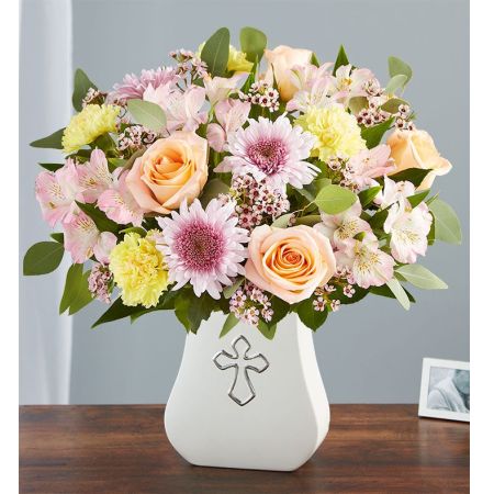 Conroy's Flowers El Cajon El Cajon - Honor someone special with our "Sacred Blessings Pastel" arrangement, a serene and lovely tribute. Gathered with peach, lavender, pink, and yellow blooms, this arrangement is elegantly presented in our Sacred Blessings vase. The vase features a silver-embossed cross, an eternal symbol of hope. This soothing floral tribute is designed to bring peace to those mourning a loss. With our same-day flower delivery, you can promptly offer comfort and support to those in need. The "Sacred Blessings Pastel" arrangement is a thoughtful and heartfelt way to convey sympathy, combining the beauty of flowers with the symbolism of hope during difficult times.





