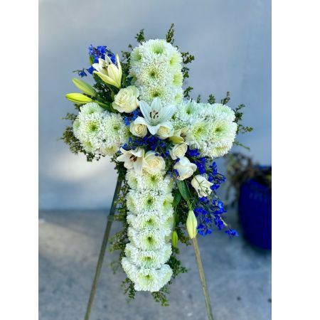 Conroy's Flowers El Cajon El Cajon - Celebrate a life of faith and devotion with "Peace & Prayers™ Blue & White Standing Cross." This elegant sympathy arrangement features a bed of pristine white blooms crafted into the shape of a cross by our caring florists. Flourishes of white and blue flowers cascade down the center, creating a beautiful tribute to honor a loved one and providing peace and comfort when it's most needed. With our same-day flower delivery, you can promptly share this beautiful and meaningful arrangement with those who are mourning. "Peace & Prayers™ Blue & White Standing Cross" is a thoughtful expression that brings solace and warmth during challenging moments, offering support and comfort.