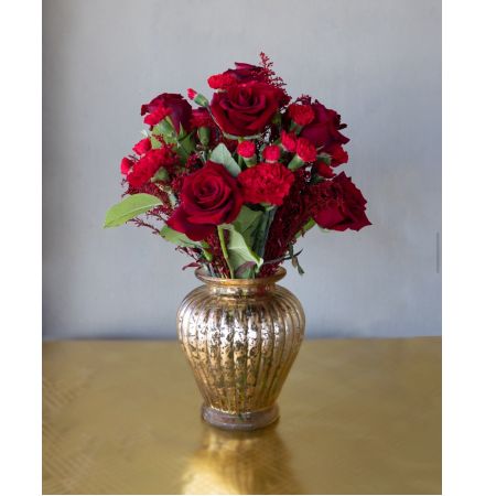 Conroy's Flowers El Cajon El Cajon - Introducing "The Golden Girl" – a stunning arrangement where red floral tones are artfully designed in an elegant gold copper finish vase. This exquisite combination is perfect for elevating any living space, adding a touch of sophistication and warmth.With our same-day flower delivery, you can promptly bring the radiant beauty of "The Golden Girl" to your doorstep, making any moment more special with this captivating blend of red blossoms and a luxurious gold copper vase.