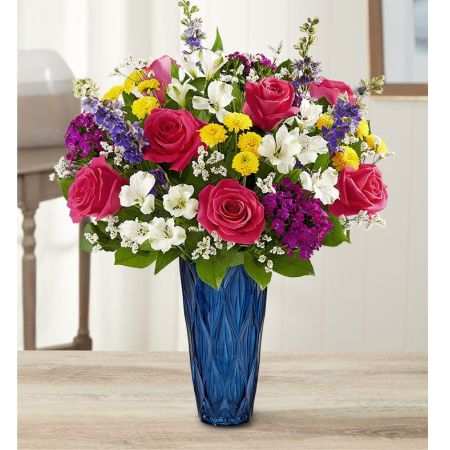 Conroy's Flowers El Cajon El Cajon - EXCLUSIVE Set the scene for special moments with our stunning arrangement. A blend of jewel tone blooms is hand gathered in our Blue Harmony vase, adding striking color and exquisite texture to this luxurious surprise.