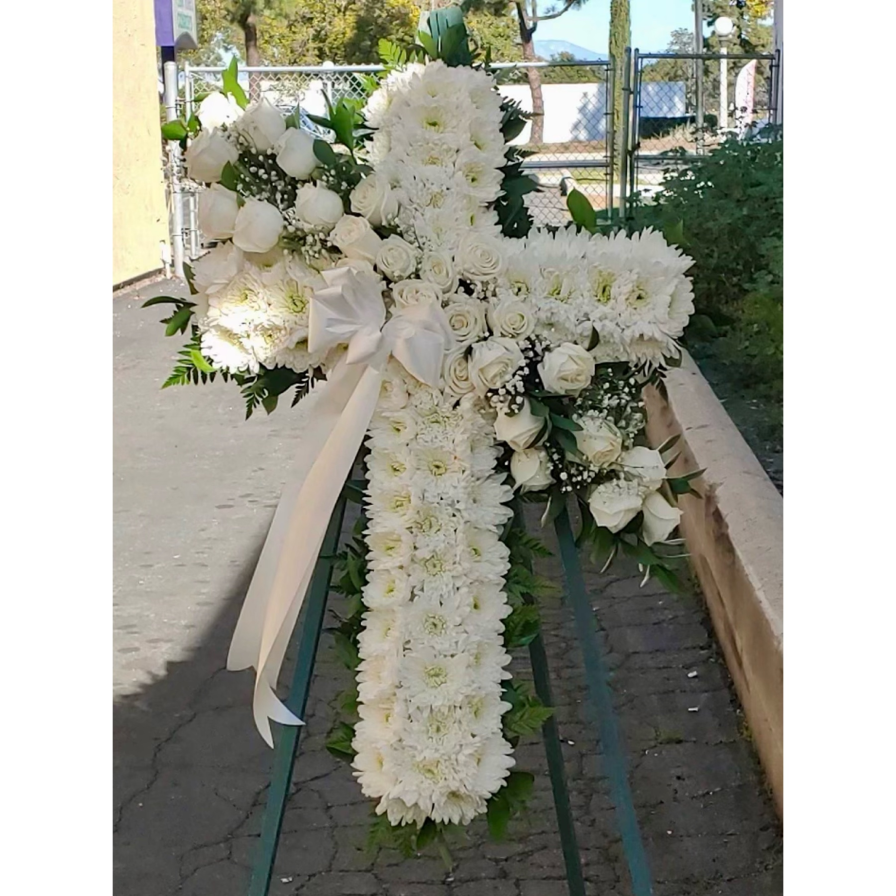 Conroy's Flowers El Cajon El Cajon - Honor a lifetime of faithful devotion with our beautiful standing cross arrangement. Our expert florists handcraft each of these impressive displays with a bed of white mums in the shape of a cross, and accent with a cascade of crisp white roses. It is a beautiful way to offer peace and comfort during a difficult time.