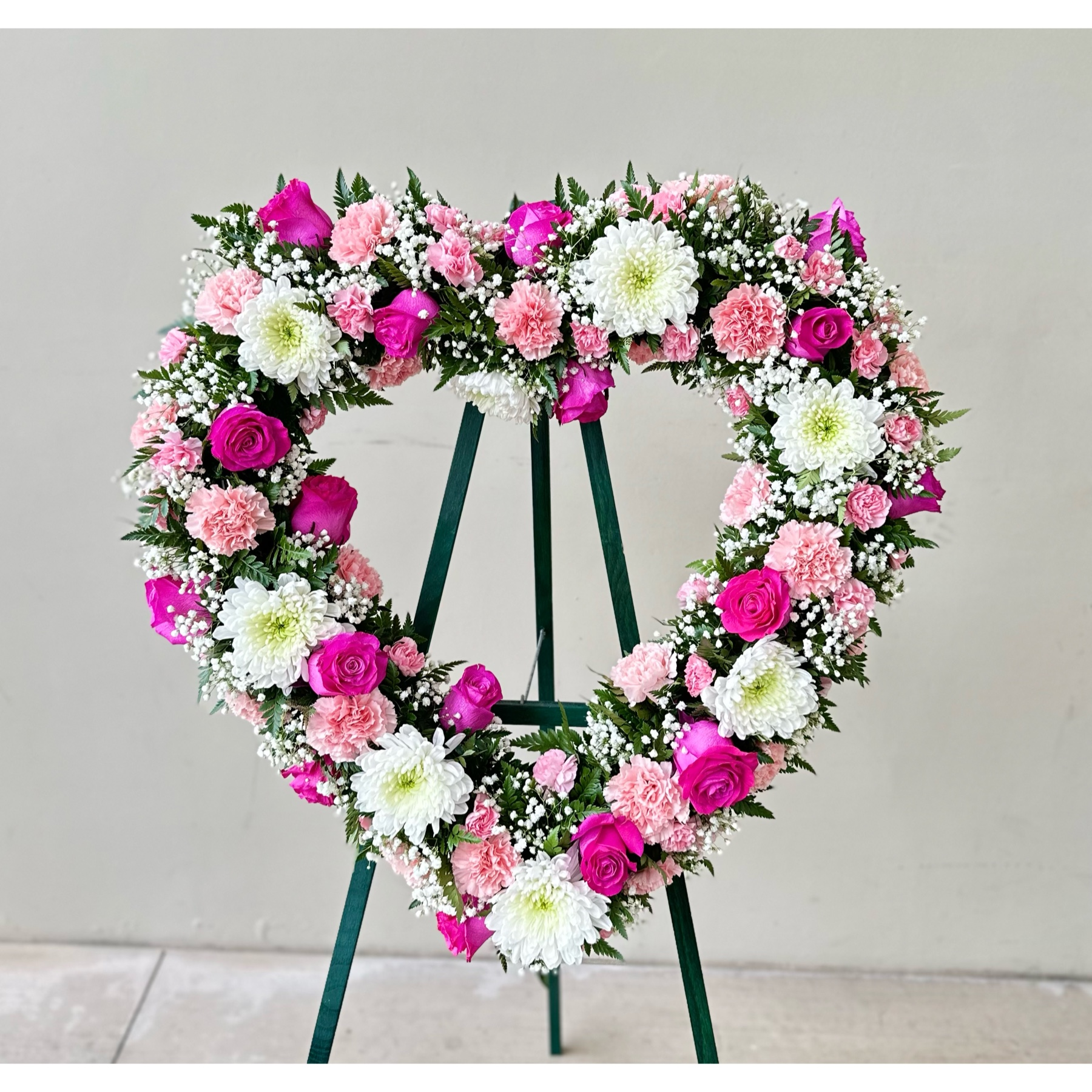 Conroy's Flowers El Cajon El Cajon - Capture the special place they hold in your heart with the "Always Remember™ Floral Heart Tribute - Pink & White." This standing, open heart-shaped arrangement in pink hues is handcrafted by our caring florists. It is a magnificent tribute fitting for the funeral services. With our same-day flower delivery, you can promptly share this heartfelt and elegant arrangement with those who are mourning. "Always Remember™ Floral Heart Tribute - Pink & White" is a beautiful expression that brings solace and warmth during challenging moments, offering support and comfort.





