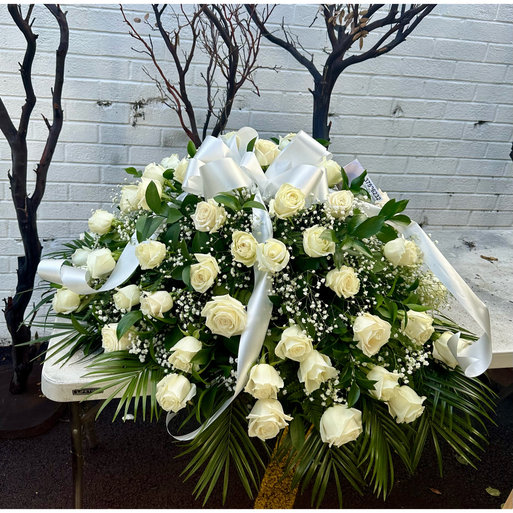 Conroy's Flowers El Cajon El Cajon - The precious moments spent with loved ones are the moments we want to hold onto forever. Capture this sentiment with a timeless display of all white. Our half casket cover, crafted with care and artistry by our expert florists with over 50 snow white roses, white monte casino, and accented with a white satin ribbon, is an unforgettable way to commemorate a lifetime of shared loving experiences.
