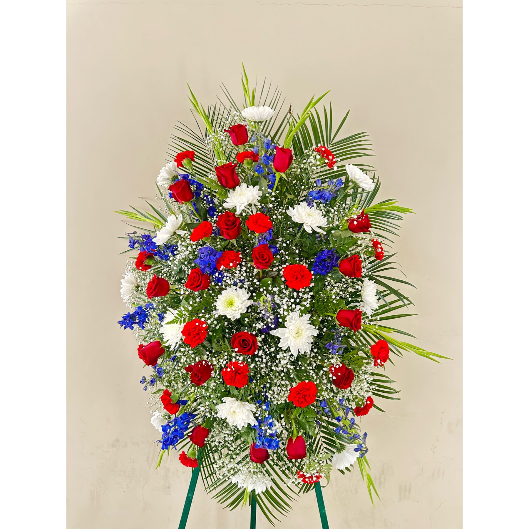 Conroy's Flowers El Cajon El Cajon - In honor of those who served their country with honor and pride, our Red, White & Blue Sympathy Standing Spray stands as a poignant remembrance. Meticulously handcrafted by our expert florists, this patriotic standing spray is dedicated to honoring the memory of a brave veteran who has passed away. Filled with fresh blooms in vibrant red, pure white, and deep blue, the arrangement offers a lush and full presentation—a proud and fitting final tribute to commemorate the service and sacrifice of the departed veteran.





