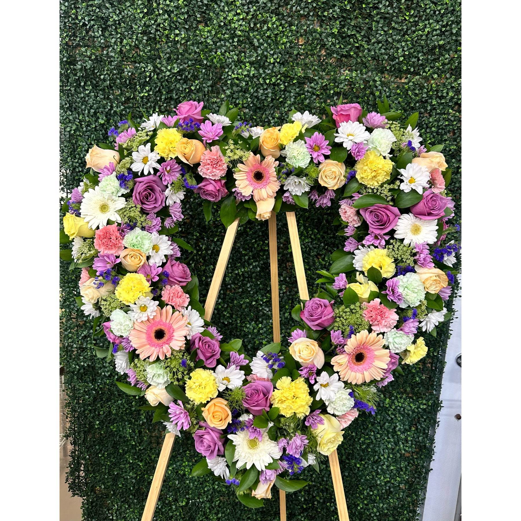 Conroy's Flowers El Cajon El Cajon - Celebrate the enduring love and warm memories of a cherished individual with our Always Remember™ Floral Heart Tribute in pastel hues. This standing, open heart-shaped arrangement is thoughtfully handcrafted by our caring florists, using an assortment of soft and gentle pastel blooms. It serves as a magnificent tribute, perfectly suited for funeral services, expressing the everlasting impact of the love they shared with those around them.





